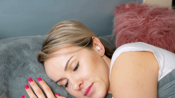 Woman using earplugs while sleeping
