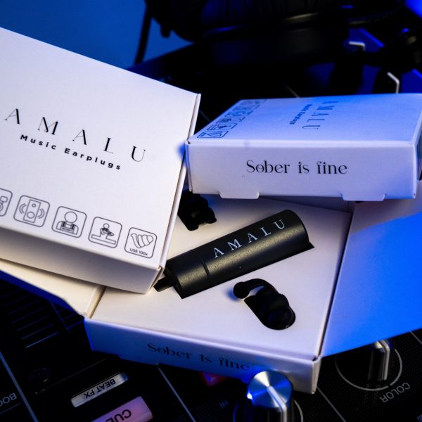 Three boxes of Amalu Music Earplugs on Dj music mixer