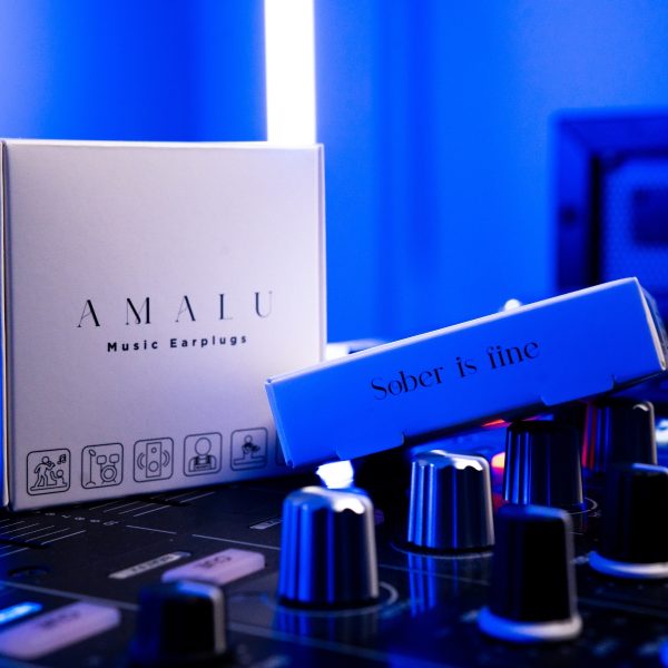 Two boxes of Amalu Music Earplugs on Dj music mixer